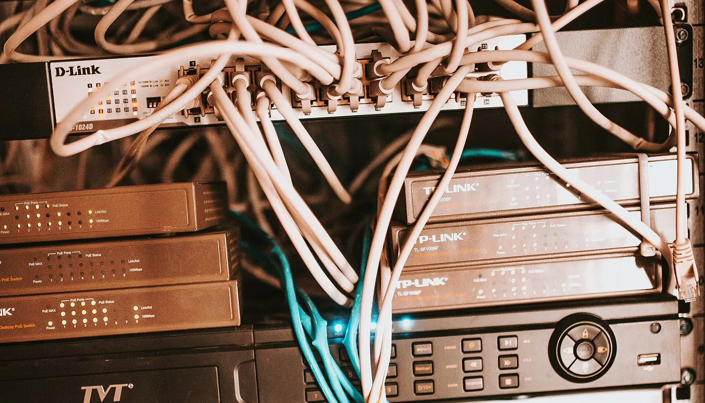 Network equipment and cables organized in a server rack at a modern office environment during the afternoon
